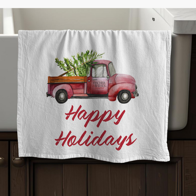 Decorative towel with a red truck and 'Happy Holidays' text on a white background
