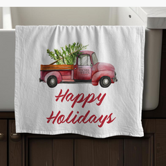 Decorative towel with a red truck and 'Happy Holidays' text on a white background